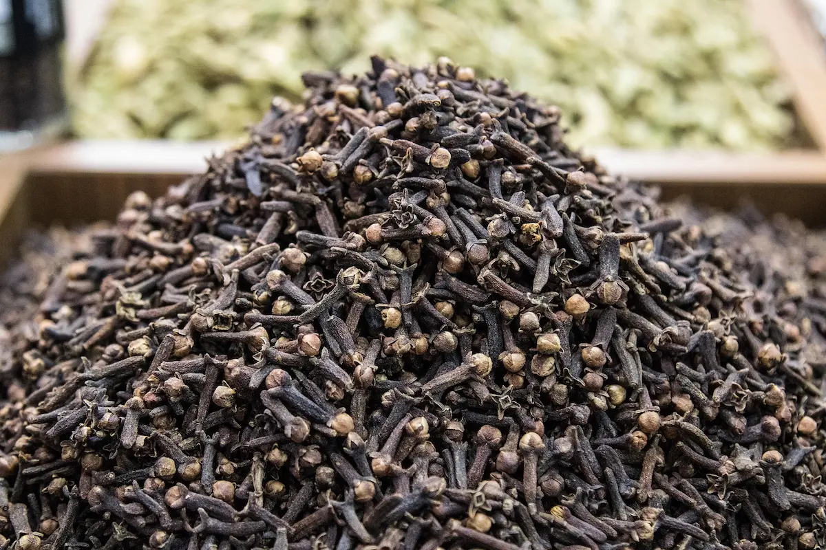 A pile of cloves, an intricate, bold, yet delicate spice.